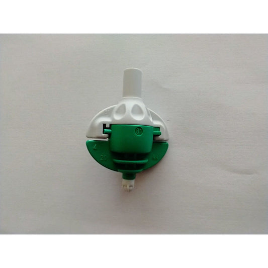 a green and white wall mounted light switch