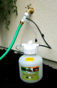 a green hose is connected to a propaner