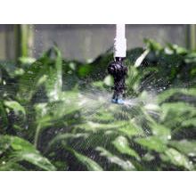 a sprinkler is spraying water on a plant